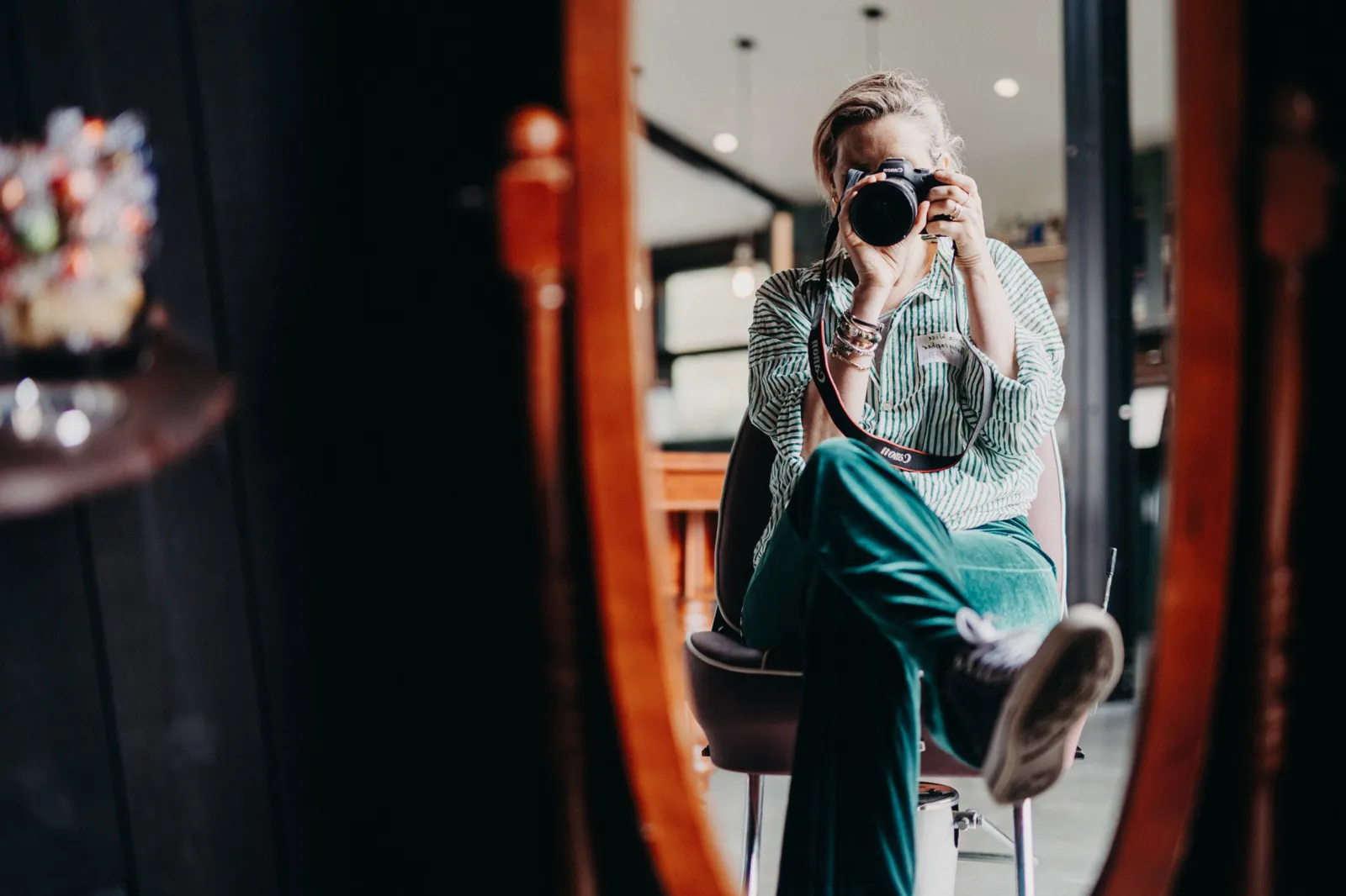 A wedding photographer taking a photo, reflected in a mirror