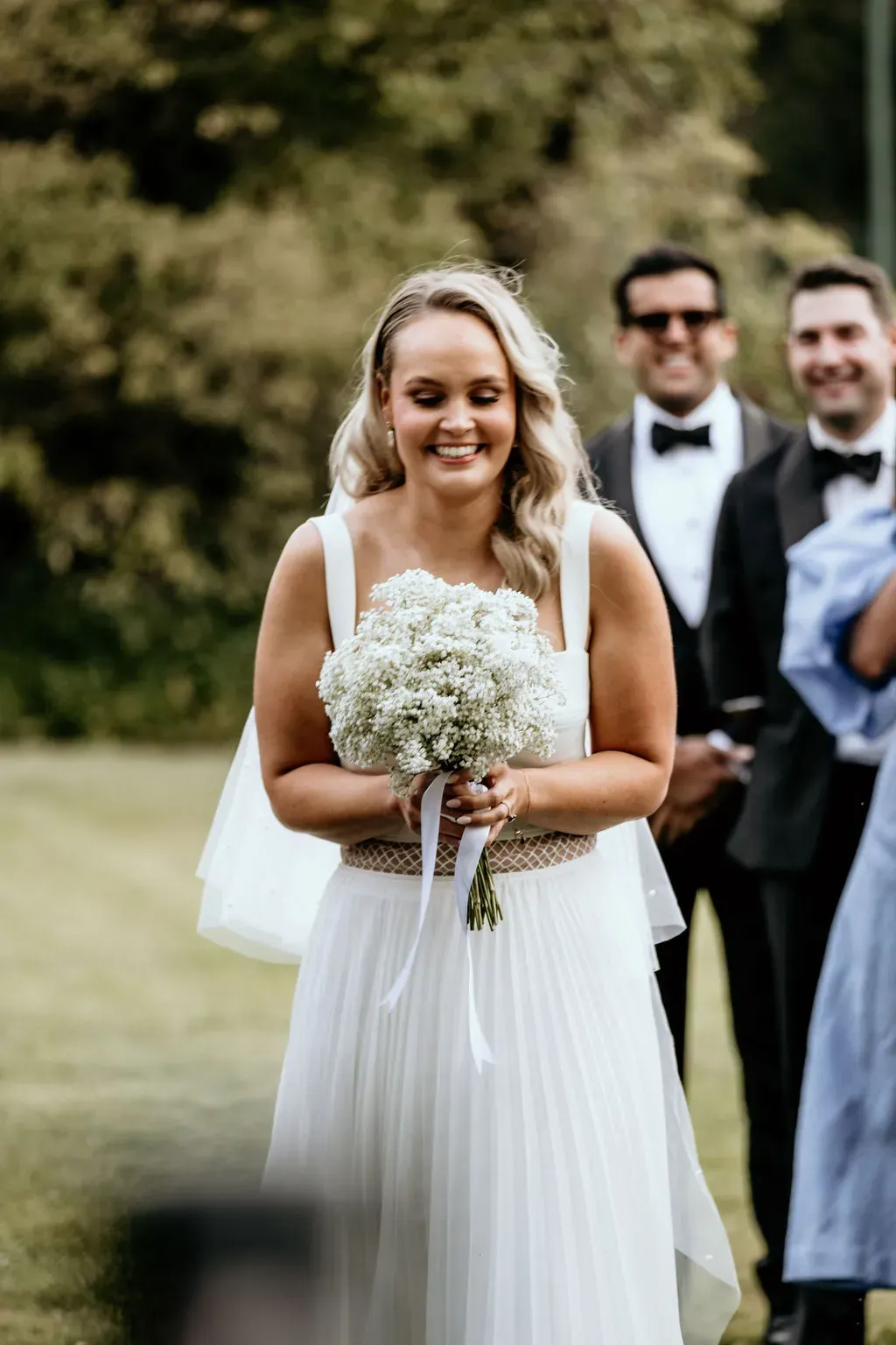 smiling_bride_ceremony_groom_in_background_302a3b96ef